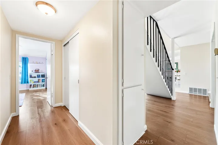 Hallway with extra closet/storage, view of  primary downstairs bedroom