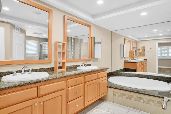 Primary bath suite with dual vanities.