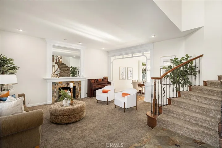 As you enter you are greeted by 2 story ceilings, a spiral staircase and a large formal living room.