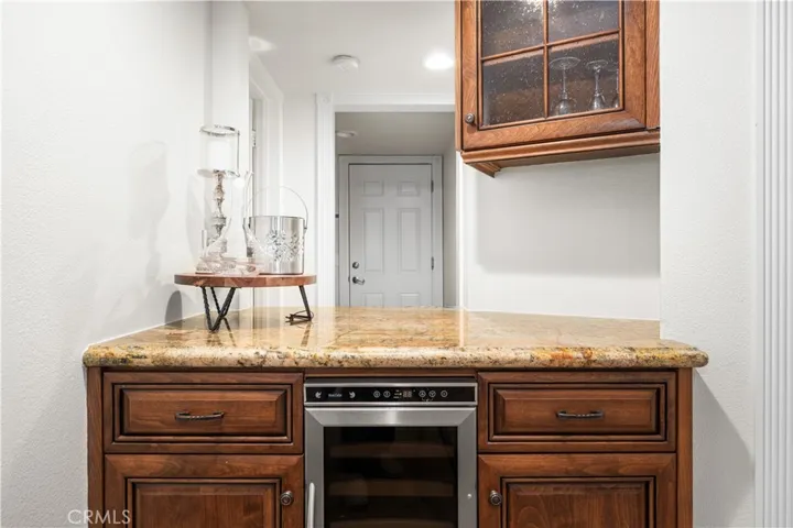 Dry bar in family room with wine fridge