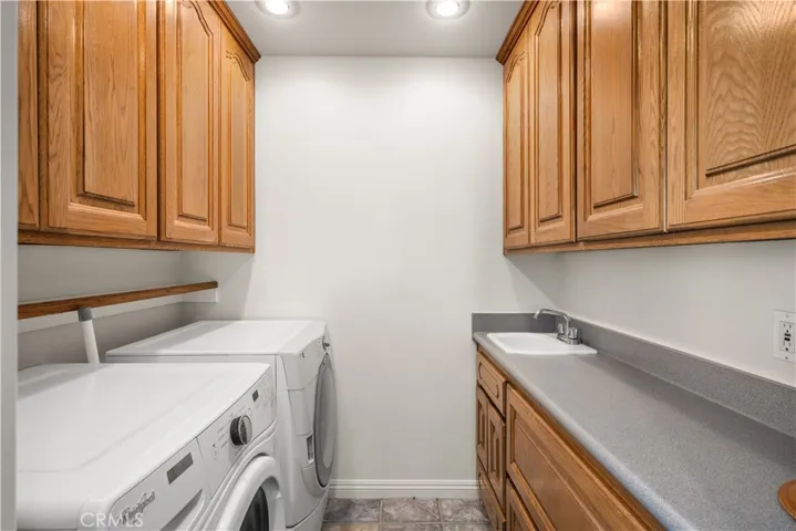 Upstairs laundry room with sink.
