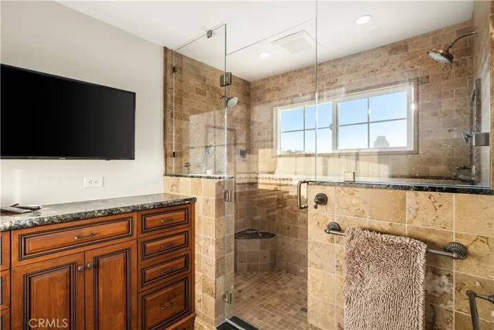 Large walk in primary shower with dual shower heads