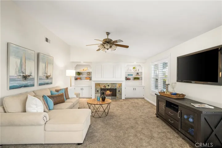 Expansive bonus room with fireplace, built-ins and shutters.