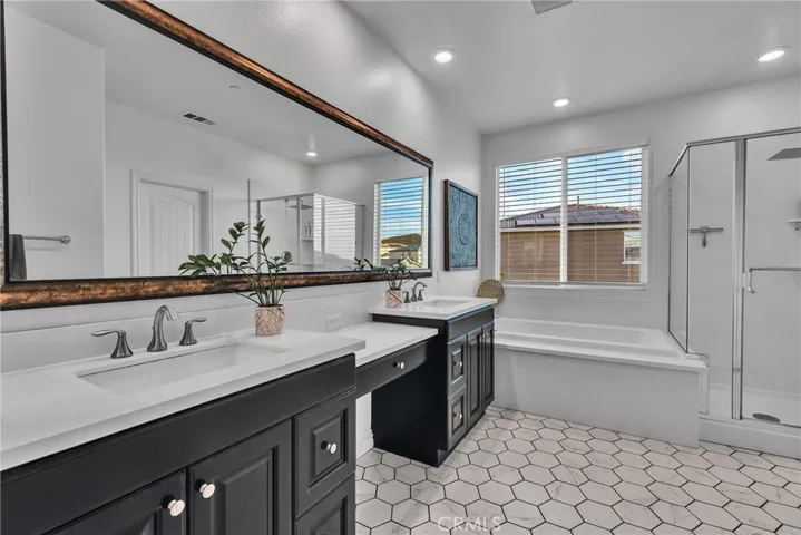 Primary suite double vanity and separate tub shower