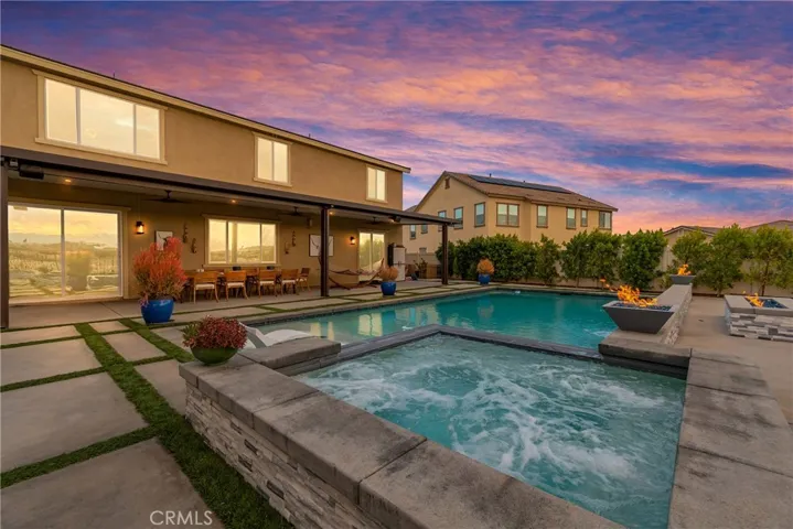 pool spa water falls and firepit as the sun sets