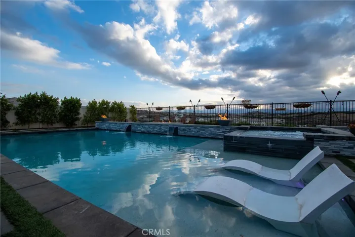 Pool baja step spa and firepits at sunset