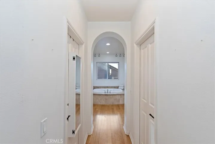 Primary Suite Hallway with His/Her Walk-In Closets