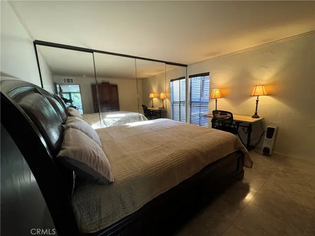 Bedroom with king bed, desk, built-ins and full room length closet