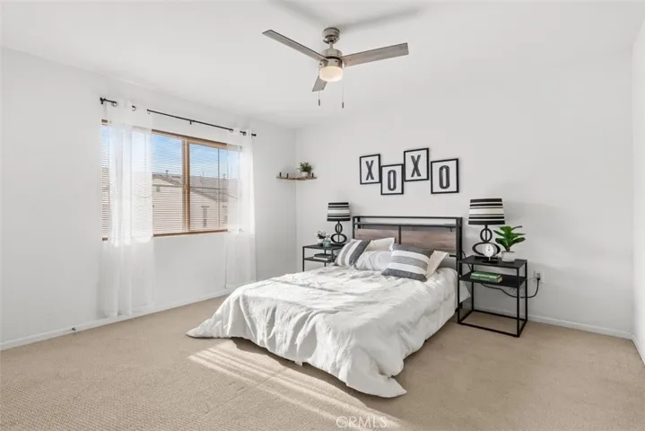 Natural lights fill the primary bedroom with two closets connected to an en-suite bathroom for maximum convenience.