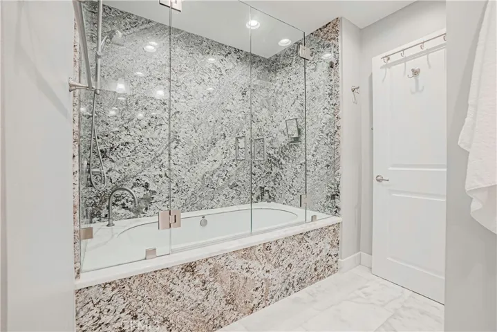 Primary Bathroom - Beautifully remodeled bath with a large and relaxing tub and expansive vanity with dual sinks and ample storage.