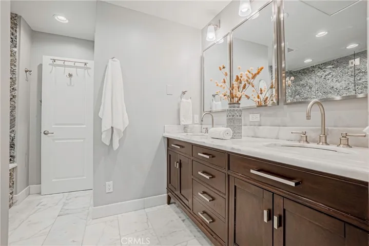 Primary Bathroom - Beautifully remodeled bath with a large and relaxing tub and expansive vanity with dual sinks and ample storage.