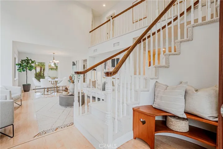 The dramatic entry brings you into the living room streaming with natural light from the high ceilings and tall windows.