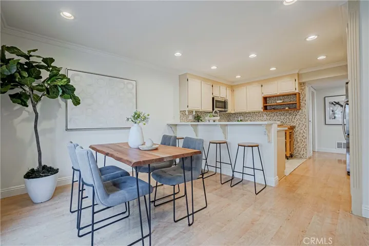 The tastefully styled kitchen features stainless steel appliances, large double ovens, induction cooktop, and it is great for entertaining, dinner parties, and ideal for everyday living with French doors that open to the backyard.