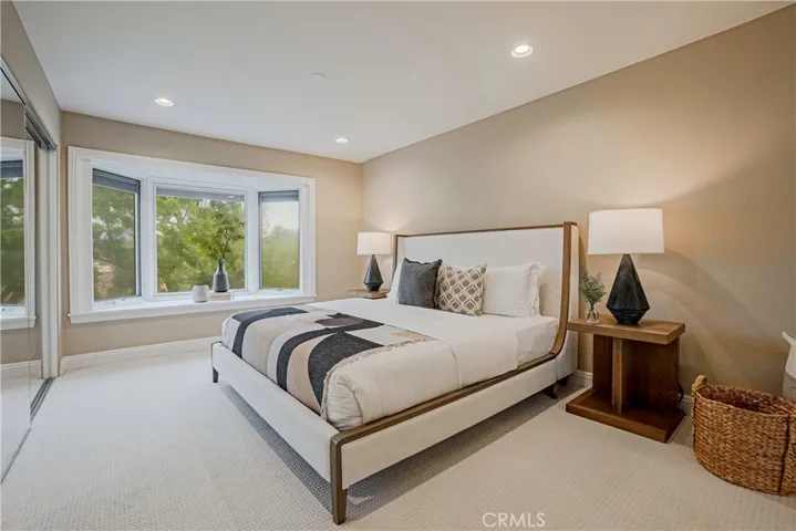 Primary Bedroom - Spacious, bright with views of the hills features a beautifully remodeled bath with a large and relaxing tub and expansive vanity with dual sinks and ample storage.