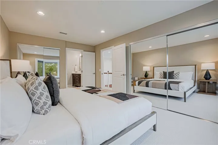Primary Bedroom - Spacious, bright with views of the hills features a beautifully remodeled bath with a large and relaxing tub and expansive vanity with dual sinks and ample storage.