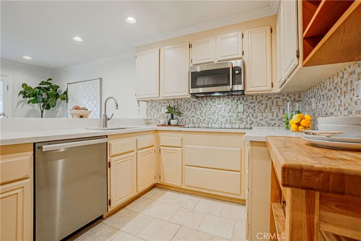 The tastefully styled kitchen features stainless steel appliances, large double ovens, induction cooktop, and it is great for entertaining, dinner parties, and ideal for everyday living with French doors that open to the backyard.