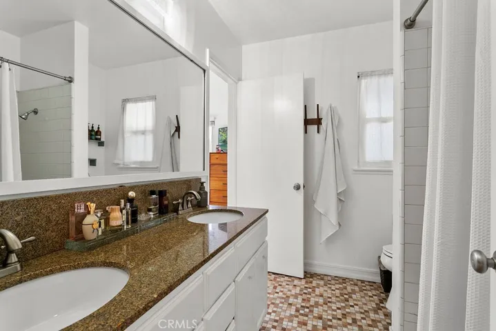 Primary bathroom with shower over tub.