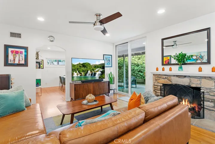 Living room with dedicated dining room (or den?) in distance.
