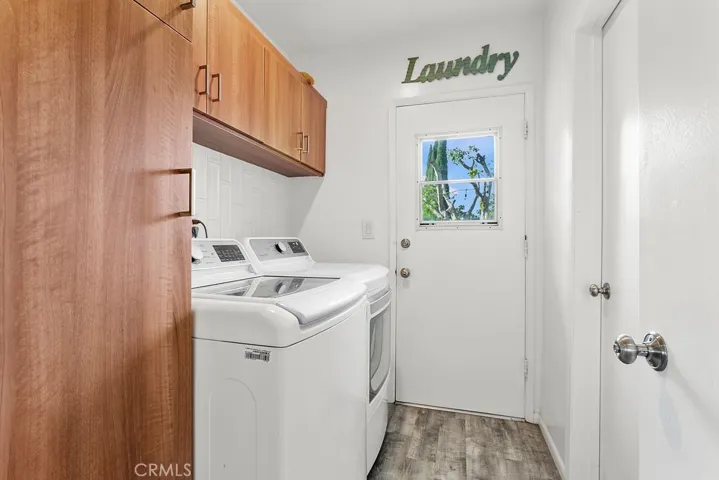 Dedicated laundry room with exterior door to side yard and garage.