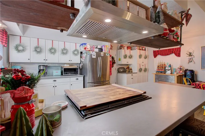 Close-up kitchen, stovetop, dining bar.