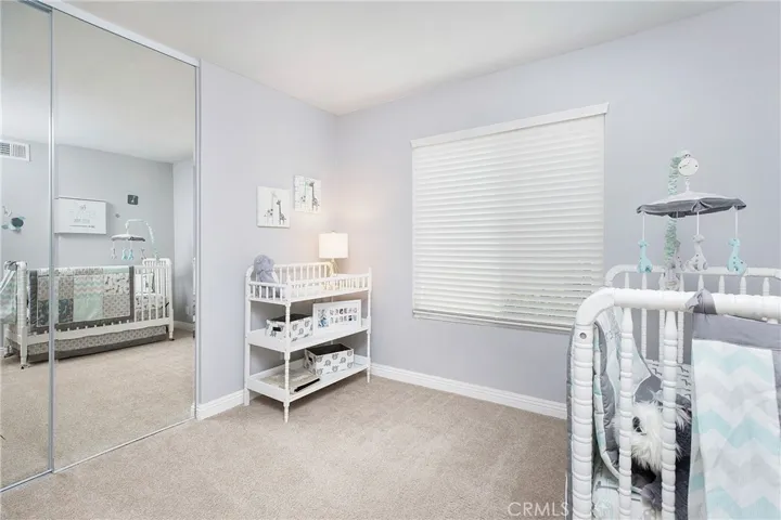 Mirrored closet doors in nursery or office or room for guests