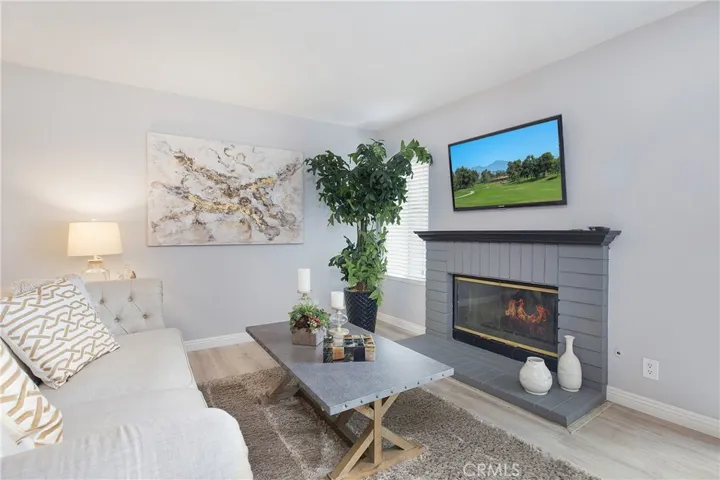 Cozy fireplace in living area-open to kitchen and dining area