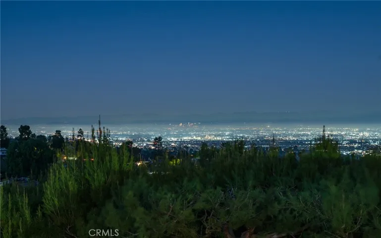 As the evening descends, the sparkling city lights come alive, painting a mesmerizing backdrop of twinkling buildings and vibrant urban energy