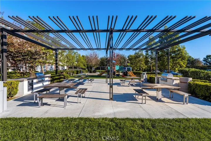 a full outdoor dining area, with multiple barbecues
