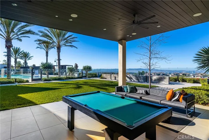 a covered game room with city-light views