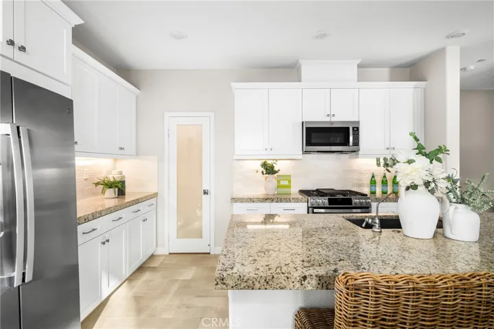 featuring a full suite of stainless-steel appliances