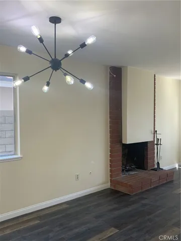 Dining area and part of the formal living room w/ a brick fireplace