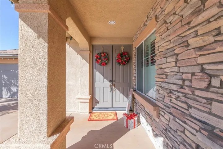 Charming and welcoming entryway with elegant stone accents.
