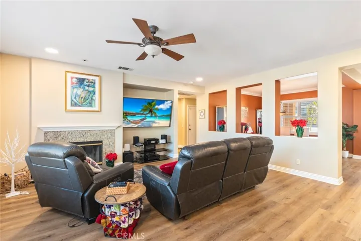 Spacious and inviting living room with a cozy fireplace, perfect for relaxing and entertaining guests.