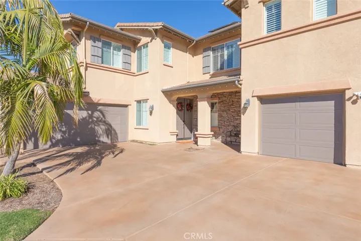 Spacious 4-car garage with an extended driveway, offering ample parking.