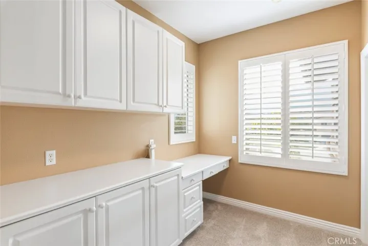 A well-organized space with built-in cabinetry and countertops, perfect for convenient storage and workspace needs.