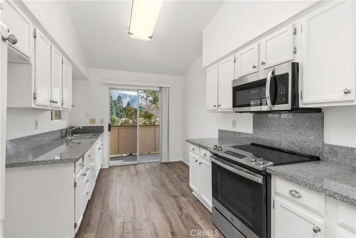  abundant natural light through the large windows and an elegant lighting fixture.