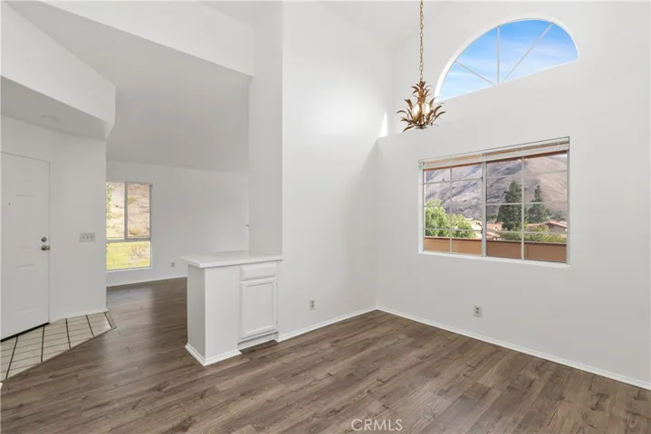  abundant natural light through the large windows and an elegant lighting fixture.