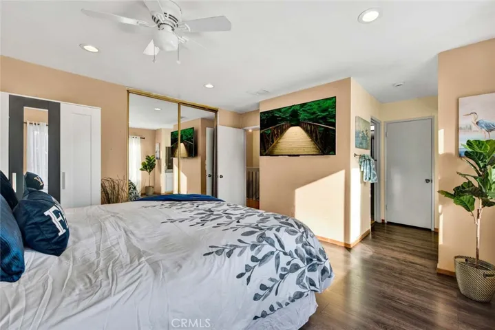 Bright master bedroom with mirrored wardrobe