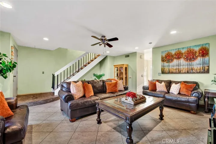 Large living room with room for formal dining under stairs