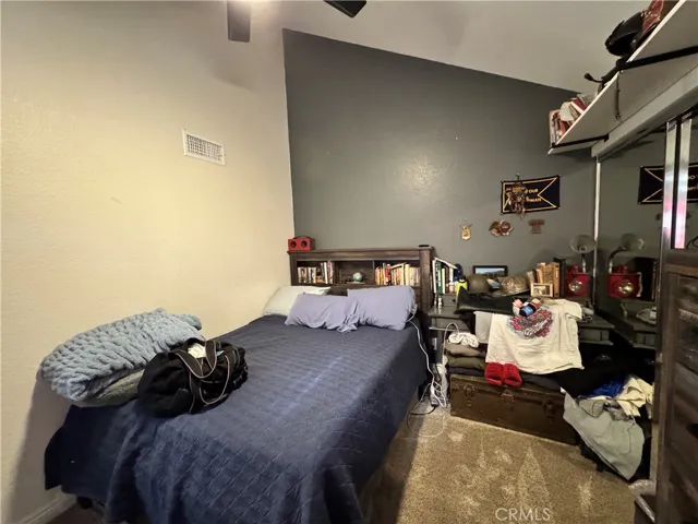 Secondary bedroom with it's own private bath. It is very light and bright but it is a teenager's bedroom so he likes it darker.