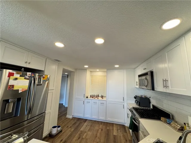 View of the kitchen from the breakfast bar. Refrigerator comes with the home too.