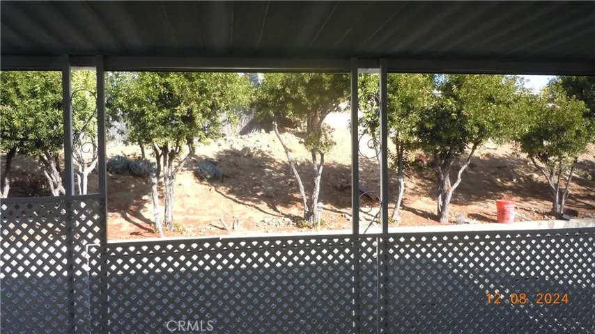 Another view from the enclosed lanai and showing the rear slope with trees for privacy.