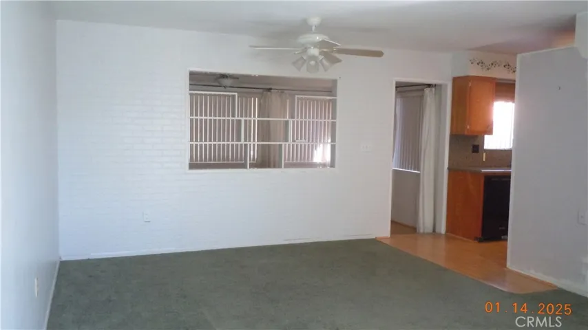In the living room with the kitchen to the right.