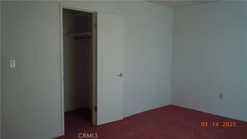 Reverse view of guest bedroom with walk-in closet.