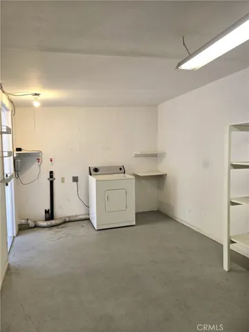 Separate laundry room off the rear patio has plenty of storage.