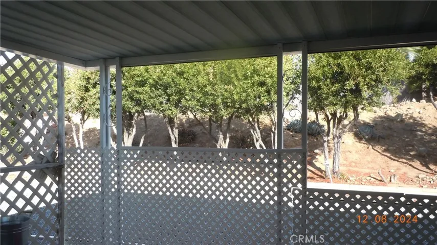 Rear patio is an enclosed lanai with trees to make your area private!