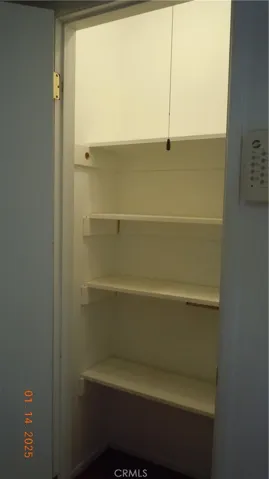 One of the two hall closets.  Appliance storage area & extra food storage.