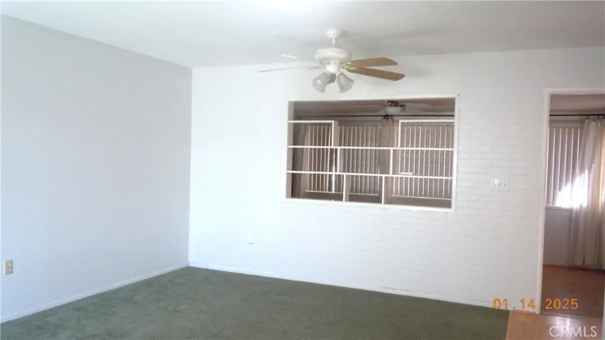 Open display shelving between living room & enclosed patio.