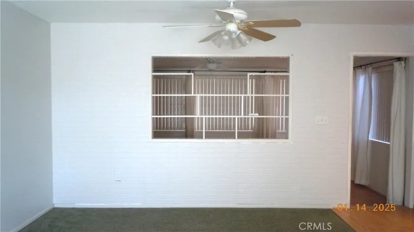 Closer view of the open display shelves between living room and enclosed patio.
