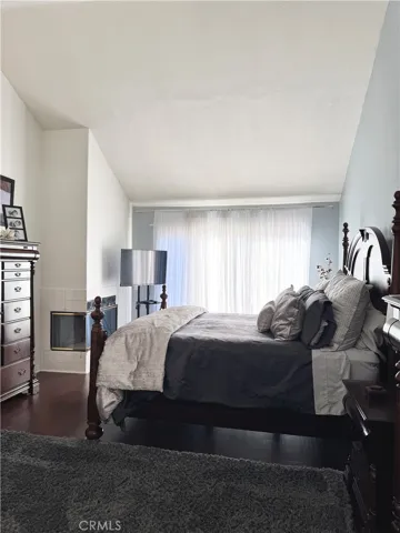 Master bedroom with fireplace and high ceiling